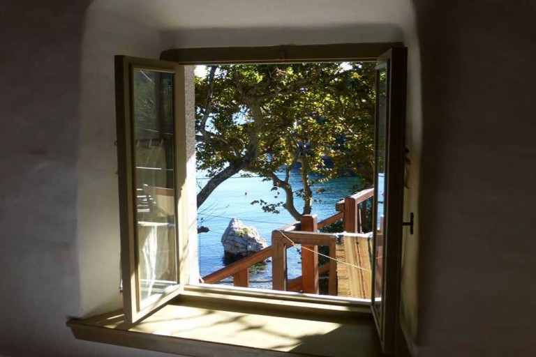 Ghermaniko guesthouse window view of Damouhari harbor